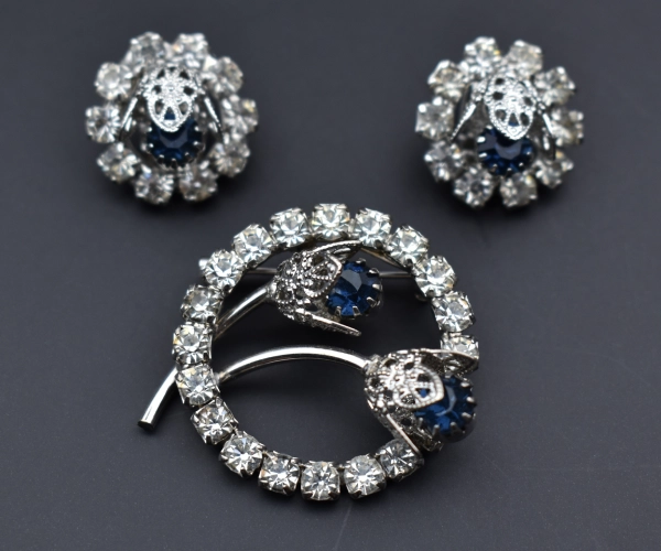 jewelry-brooch-earrings-with-blue-diamonds-black-background