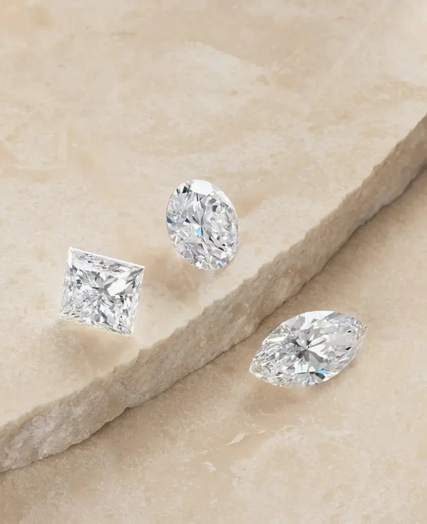 a_collection_of_loose_diamonds_spread_on_a_stone_slab